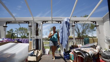 Yeppoon resident Demelza Bischoff walks onto the roofless veranda of her home, after it was damaged during Cyclone Marcia.