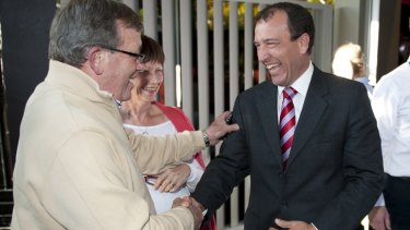 Mal Brough is congratulated by an LNP supporter after winning the Fisher preselection ballot held at the Caloundra RSL.
