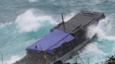 Disaster unfolds ... the SIEV 221 smashes against rocks on Christmas Island.