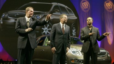 No more free cars ... Tiger Woods, right, introduces the 2008 Buick Enclave in Pasadena, California.