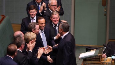 Prime Minister Tony Abbott congratulates Treasurer Joe Hockey after he delivered his first budget at Parliament House in May.