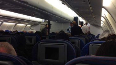 Incident in the air: a police officer is seen on the plane after it was diverted.