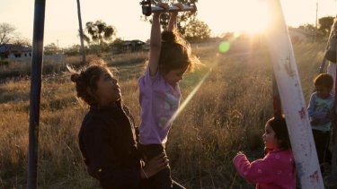 Moree has one of the highest levels of crime in the state: Rosetta Tighe helps Brianna Fernando on the swings in the old mission section of South Moree.