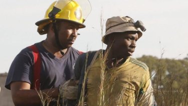 A suspected illegal miner is led away after being rescued.