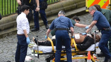 Khalid Masood is treated by emergency services outside the Houses of Parliament London. 