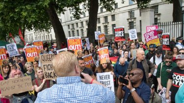 Protesters outside Downing Street in London call on the PM to resign.