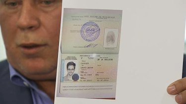 Anatoly Kucherena showing a temporary document to allow Edward Snowden to cross the border into Russia.