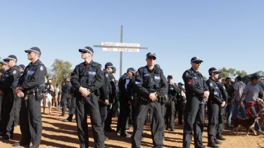 50 police surround 'Barnett crucifying the Kimberley' cross.