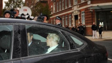 WikiLeaks founder Julian Assange, back to camera,  is driven into Westminster Magistrates Court in London after being arrested on a European Arrest Warrant.
