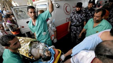 Medics wheel a wounded man into the emergency room at Gaza's Shifa Hospital.