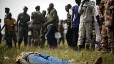 A man lies wounded after being stabbed by newly enlisted soldiers moments after Central African Republic Interim President Catherine Samba-Panza addressed the troops in Bangui.