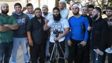 Kings Cross bouncer turned Islamic State recruiter Mohammad Ali Baryalei working for  the Street Dawah movement in Sydney. Some of the men in the photo have travelled to the Middle East.