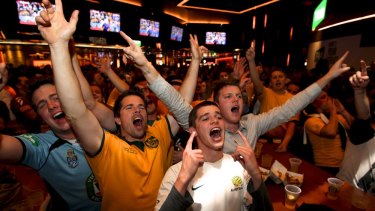 Football fans watch the Australia v Holland World Cup match at the Star's Sports Bar.