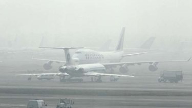 Planes are blanketed by smog at Domodedovo Airport in Moscow