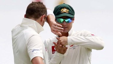 Australia's captain Michael Clarke plots with teammate Peter Siddle.