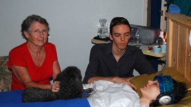 Theda's partner Blake Graham, mother Carol Adams and family dog Maggie keep a vigil at the bedside of her Willetton house.