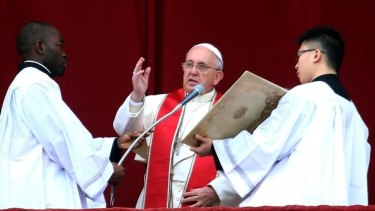 Pope Francis delivers his Christmas Day message from the central balcony of St Peter's Basilica.