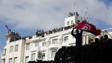 A flag-waving protester outside the Interior Ministry in Tunis.