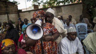 Free speech: a man whispers in the ear of a Muslim woman voicing her complaints to visiting Central African Republic Prime Minister Andre Nzapayeke in the capital Bangui on June 7.