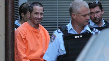 Smiling assassin ... Walter Marsh leaves court after receiving a life sentence for murder.