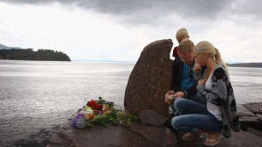 Members of the public pay their respects near Utoya island following Friday's twin extremist attacks.