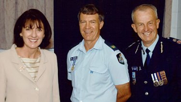 Senior Sergeant Mick Isles (centre) with former state Police Minister Judy Spence and Queensland Police Commissioner Bob Atkinson.