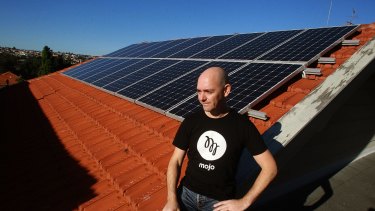 Darren Miller at home with his solar panels. 