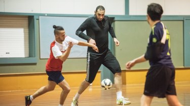 Alaa El Zokm playing his weekly post-prayer soccer match against the young men of the mosque.