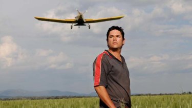 Besieged ... James Barlow, who wants guarantees his farm will not be touched by miners, oversees aerial dressing from a paddock of his property, which is sandwiched between two large coalmining sites.