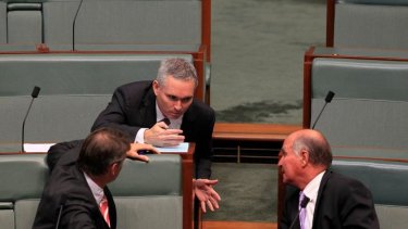 Independent MP Craig Thompson talks with Rob Oakeshott (left) and Tony Windsor (right) during question time at Parliament House.