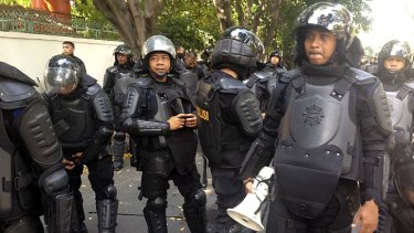 Street protest: Riot police protect the Myanmar embassy in Jakarta.
