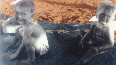 Phillip Noble and Ross Munroe play in a sand pit of asbestos. Photo courtesy of the Asbestos Diseases Society of Australia.