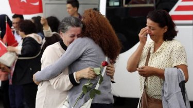 An employee at Turkey's consulate in the northern Iraqi city of Mosul is welcomed by family at Esenboga airport in Ankara, after Turkish intelligence secured the release of more than 40 diplomatic staff held by Islamic State after its capture of the city in June.