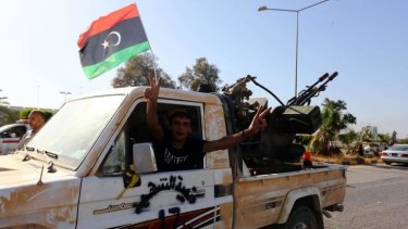 An Islamist fighter from the Fajr Libya coalition flashes the V sign for victory at the entrance of Tripoli international airport after capturing it from Zintan force, allies of rogue general Khalifa Haftar, following many days of clashes.