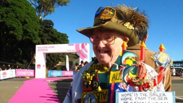 Patrick Lee, 89, is decked out in iconic Australian gear and a Neptune-like pitchfork, await's Jessica Watson's return outside the Sydney Opera House.