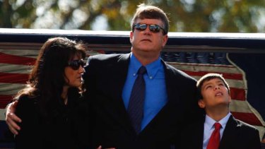 Roxanna and John Green, parents of Christina-Taylor Green, and their son Dallas Green at her funeral.
