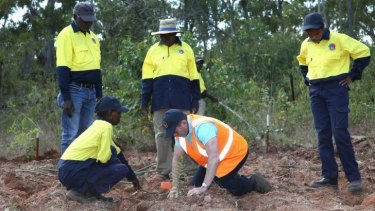 Down to earth: Prime Minister Tony Abbott assists with a tree planting in north-east Arnhem Land on Monday.