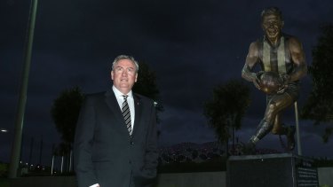 Collingwood President Eddie McGuire at the Lou Richards statue at Collingwood Football Club.