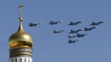 Flexing its muscle ... Russian military jets fly above the Kremlin, with the Ivan the Great Bell Tower seen in the foreground, during the Victory Day parade in Moscow's Red Square.