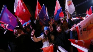 Loyalists: Supporters of the ruling AK Party celebrate in the streets of Ankara, with some holding up four fingers to encourage Mr Erdogan to push for a fourth term as PM.