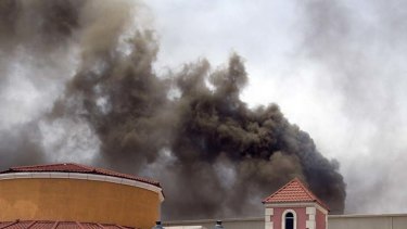 Thirteeen children dead ... smoke rises above the mall.