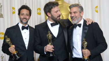 Ben Affleck, centre, jokes with George Clooney, right, and Grant Heslov after winning the Oscar for Best Picture for their film <i>Argo</i>.