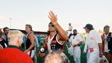 A defiant Nicky Winmar defies taunts from the Victoria Park crowd.