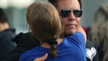 Don Damond gets a hug from a supporter shortly after he arrived for a memorial service.