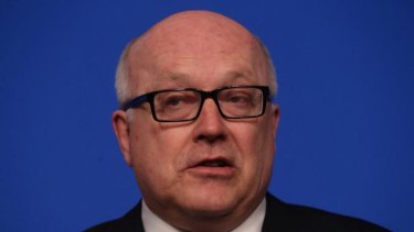 George Brandis says new national security laws won't target journalists, but his department says they will if the journalists are "reckless".