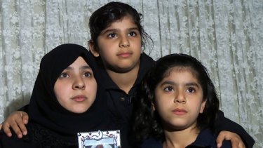 Lesson forgotten: Survivors of the refugee boat SIEVX that sank off Java eight years ago; Najah Zubaydi, with her daughters Anfal, 9, centre and Naba, 8,  and a photo of her 18-month-old son Karrar who  drowned.