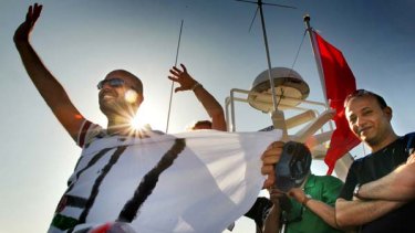 Activists on the Amal passenger boat wave farewell as they set sail from Aghios Nikolaos in Crete, Greece, to join the Free Gaza flotilla.