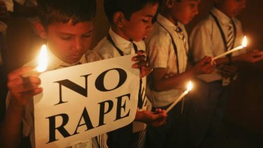 Students in Ahmedabad hold candles as they pray during a candlelight vigil for a gang rape victim who was assaulted in New Delhi.