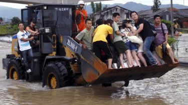 Typhoon chaos ... an excavator aids residents in China's Zhejiang province.