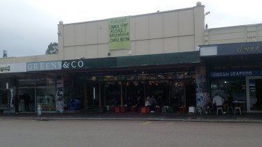 The sign hanging off Greens & Co after the incident at Vincent Council.
